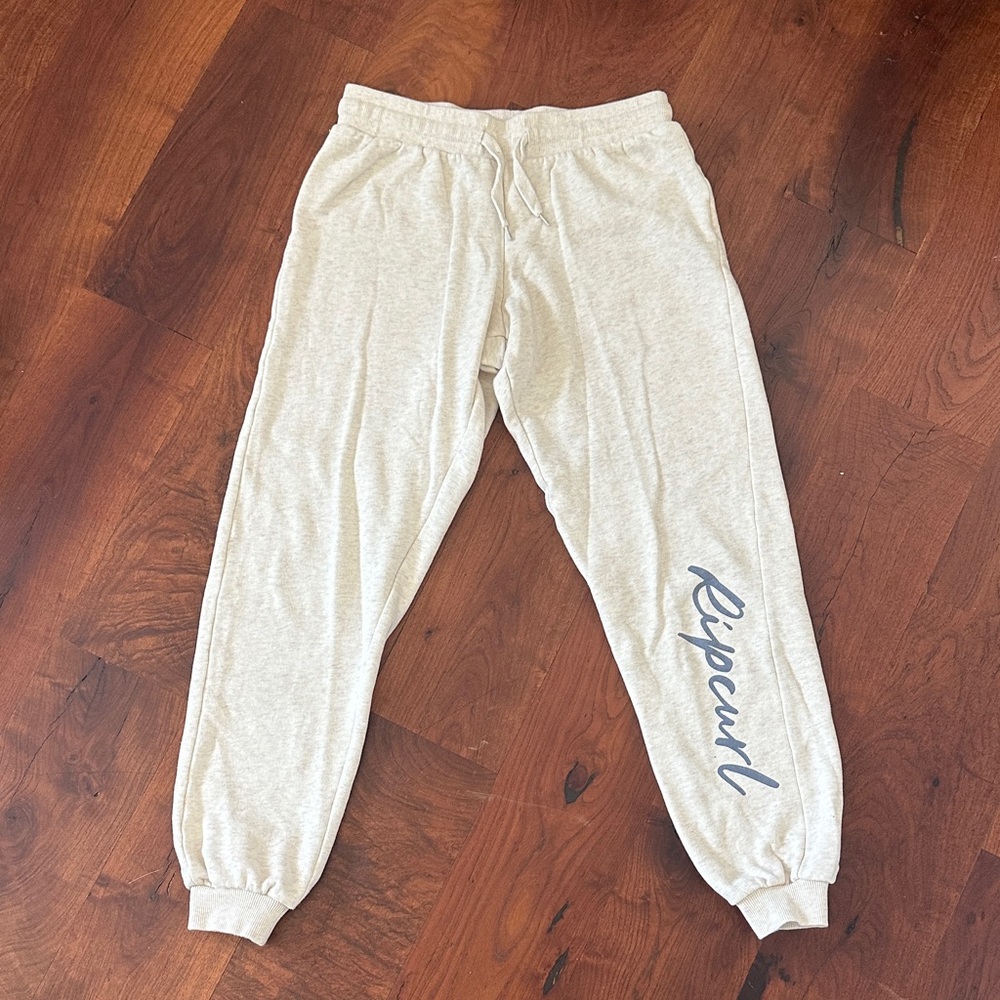 Rip Curl cream cuffed sweatpants with Blue Logo